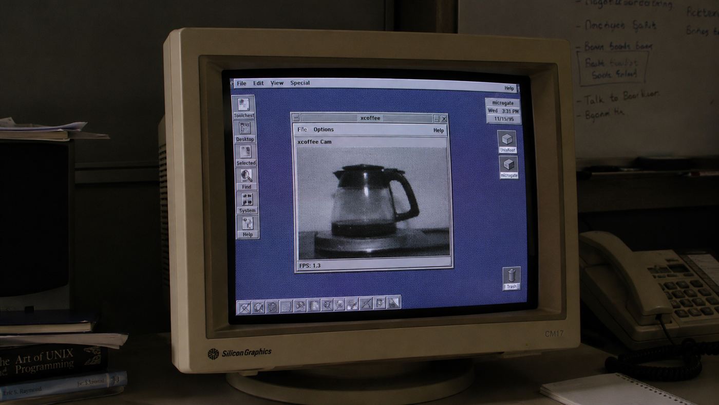 A chunky 1990s CRT monitor showing a small grainy greyscale image of a coffee pot in a window