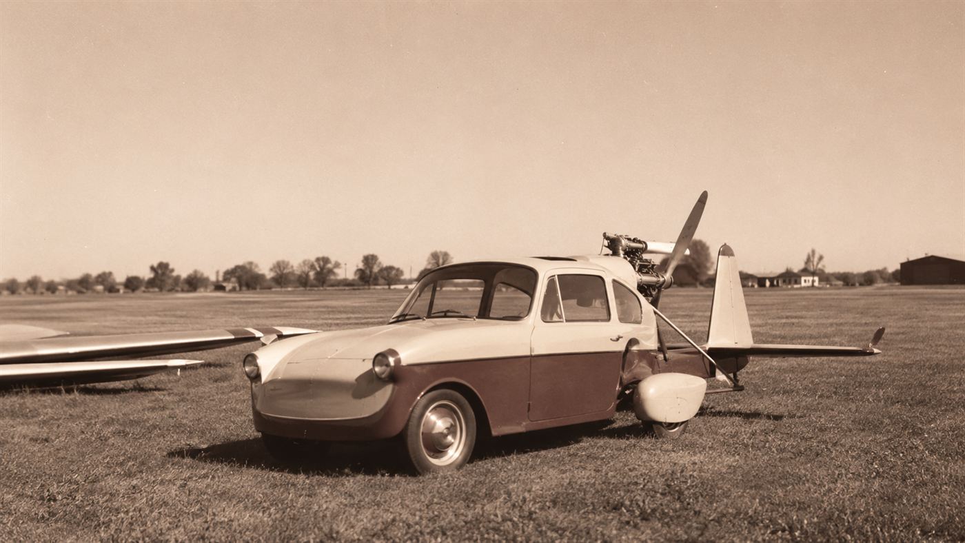 The Aerocar, a small 1950s roadable aircraft with a car body, propeller tail and detachable wings, parked on an airfield