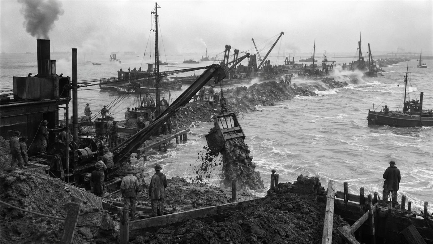 1930s workers and dredging boats dumping boulder clay to build the Afsluitdijk dam across open water