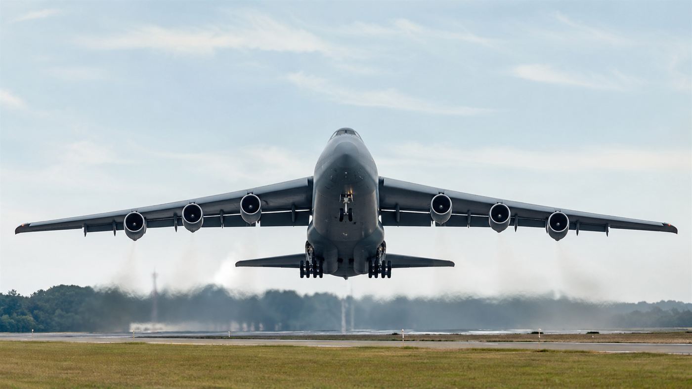 The Antonov An-225 Mriya, a vast six-engined cargo aircraft, taking off against a wide sky