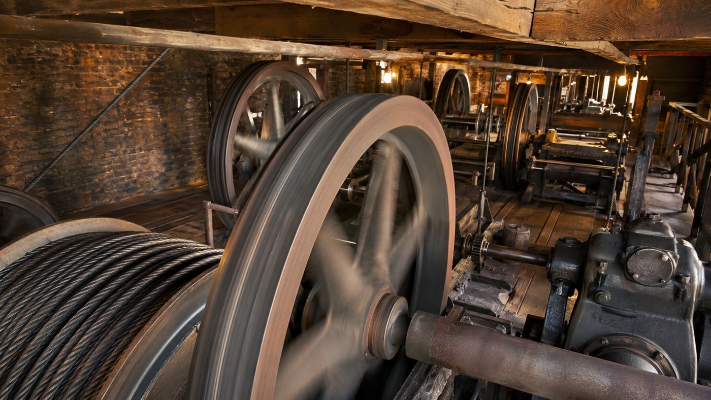 The inner workings of a cable railway power house with large sheave wheels winding thick steel cables