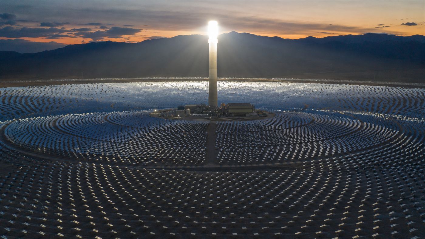 The glowing central tower of the Crescent Dunes solar plant ringed by mirrors in the desert
