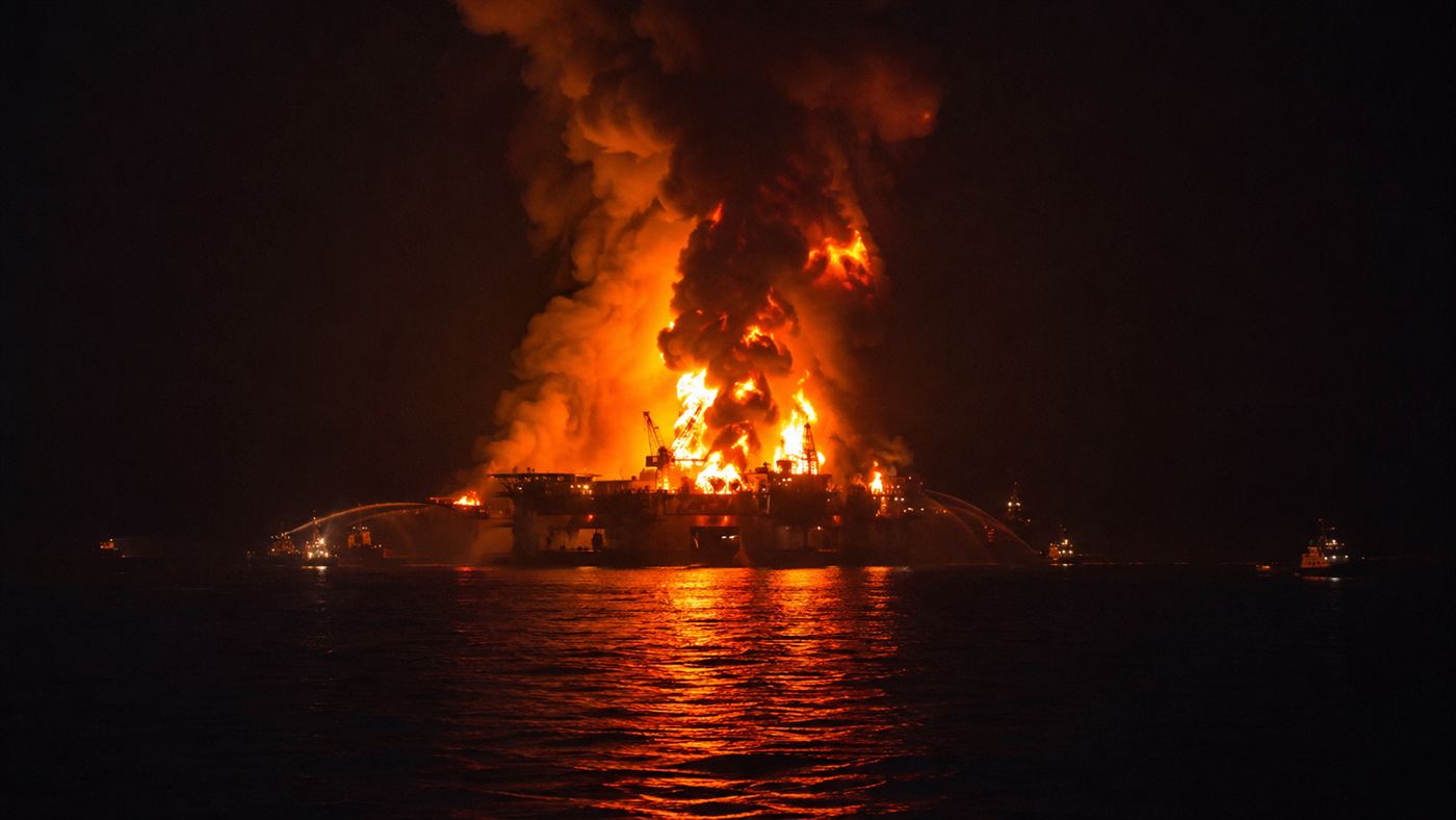 Deepwater Horizon oil rig burning in the Gulf of Mexico on April 21 2010, black smoke rising from the platform above the water before the rig sank