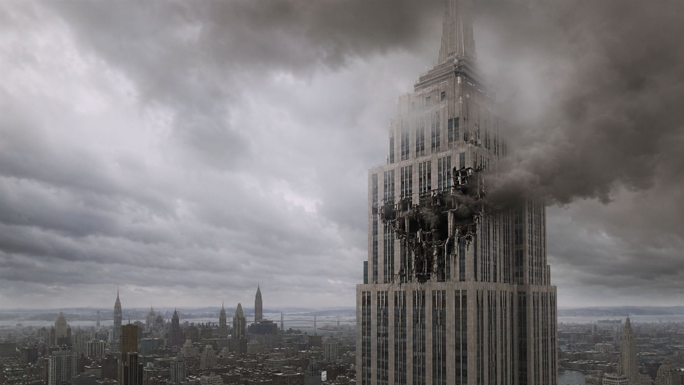 The upper floors of the Empire State Building wreathed in fog with smoke pouring from a gash where a bomber struck in 1945