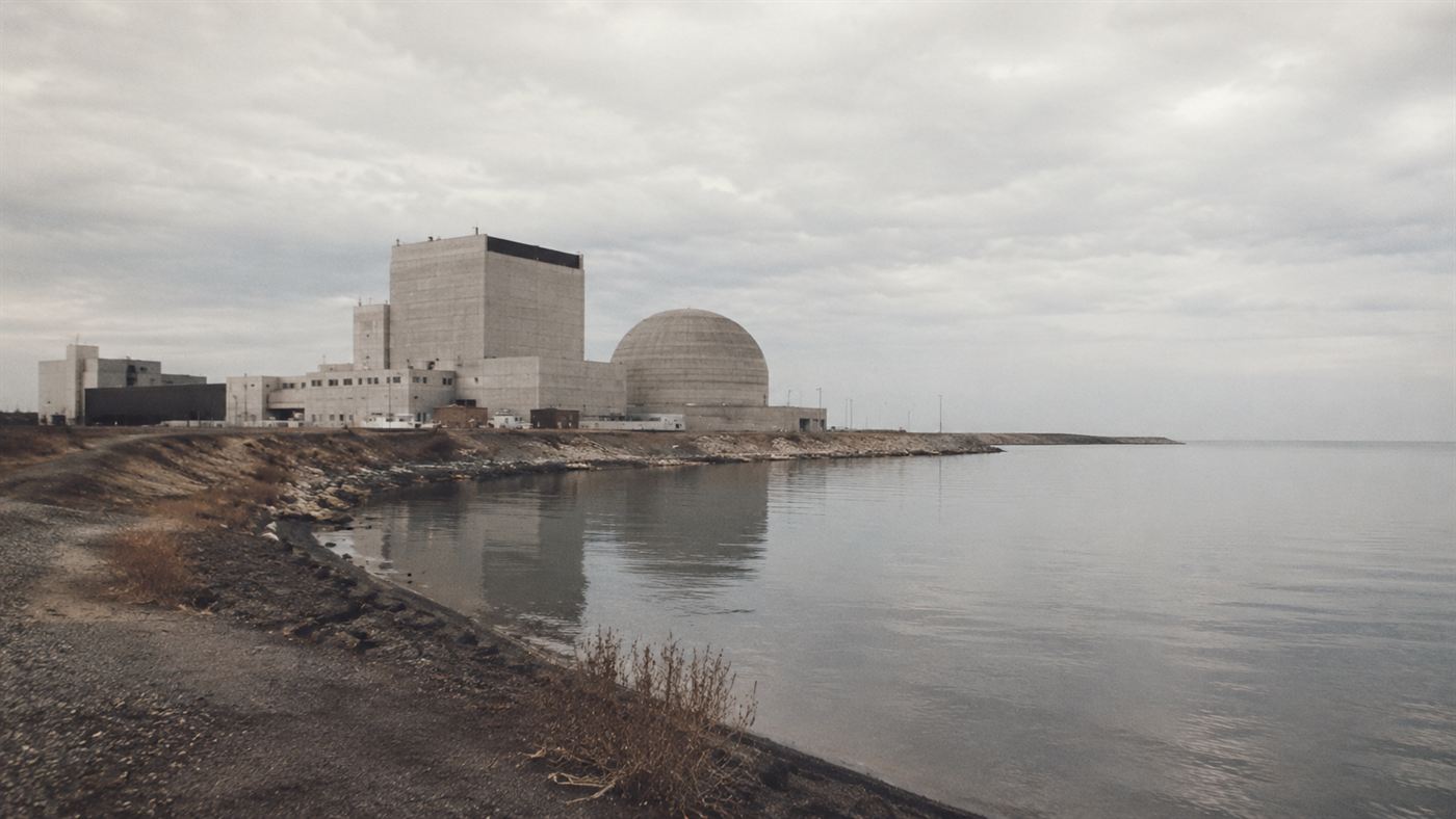 The Fermi 1 nuclear power plant on the flat shore of Lake Erie near Detroit in the 1960s, a boxy reactor building by the water