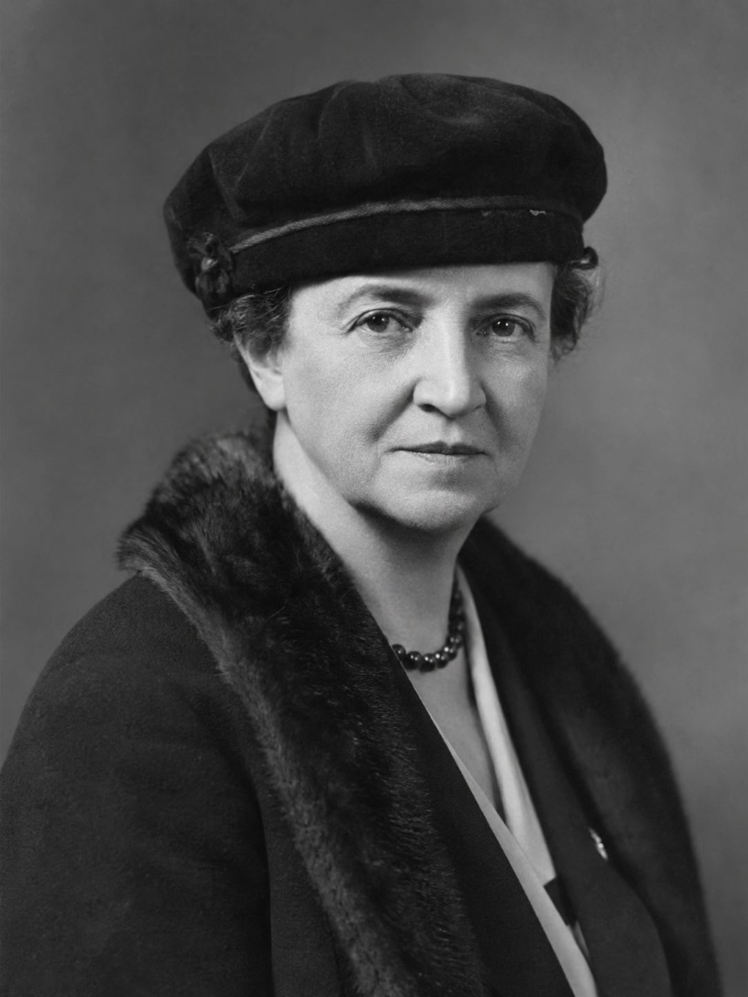 Frances Perkins, United States Secretary of Labor under President Franklin Roosevelt, formal portrait in 1930s era clothing, the first woman to serve in a US presidential cabinet, champion of American labor reform