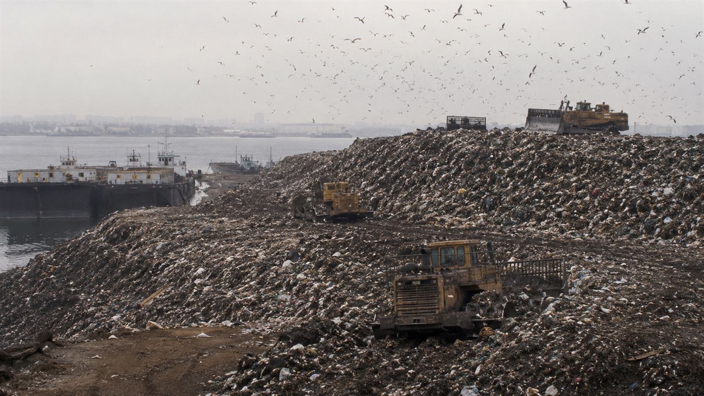 The Fresh Kills landfill in the 1990s, mountains of garbage with gulls and bulldozers on Staten Island