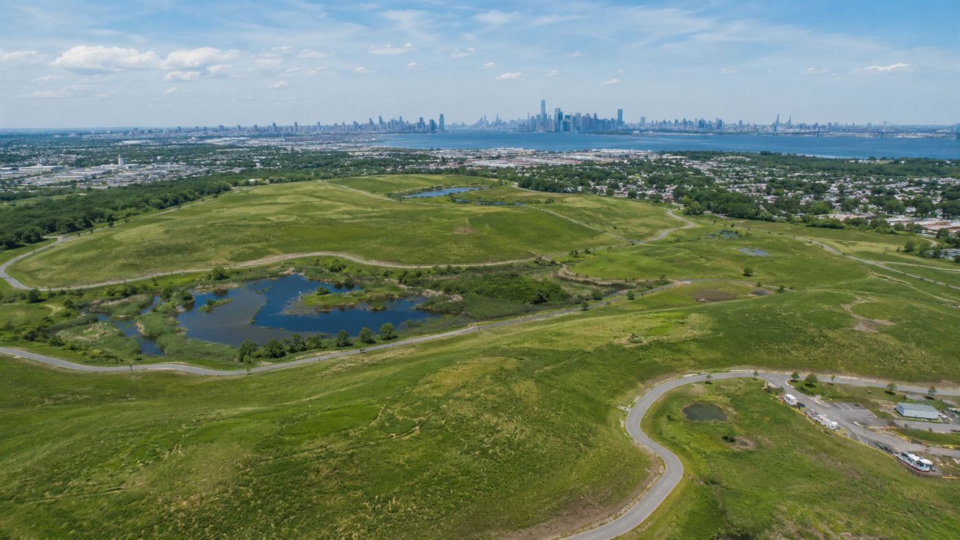An aerial view of the grassy mounds of the former Fresh Kills landfill on Staten Island, now Freshkills Park