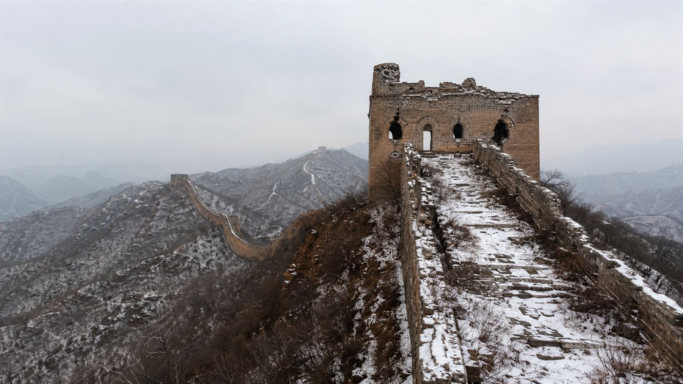 A crumbling Ming watchtower on a snowy section of the Great Wall of China