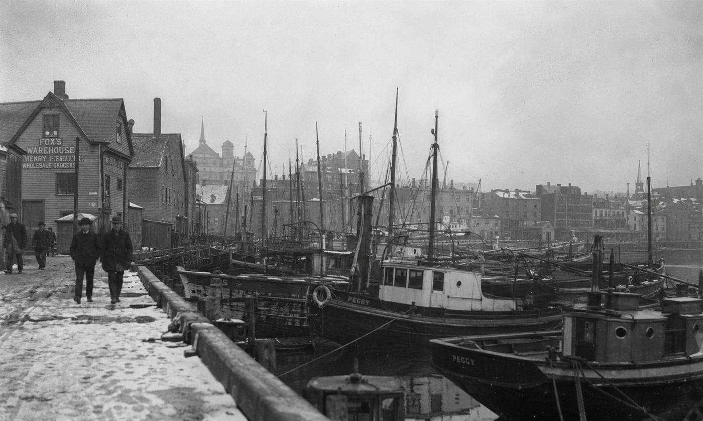The devastated north end of Halifax Nova Scotia after the 1917 explosion, collapsed wooden buildings and rubble covering wide streets, rescue workers picking through ruins, bleak winter sky, World War One era documentary photography
