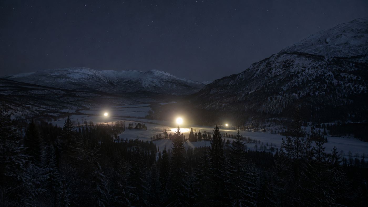 Glowing orbs of the Hessdalen lights hovering over a dark snowy Norwegian valley at night