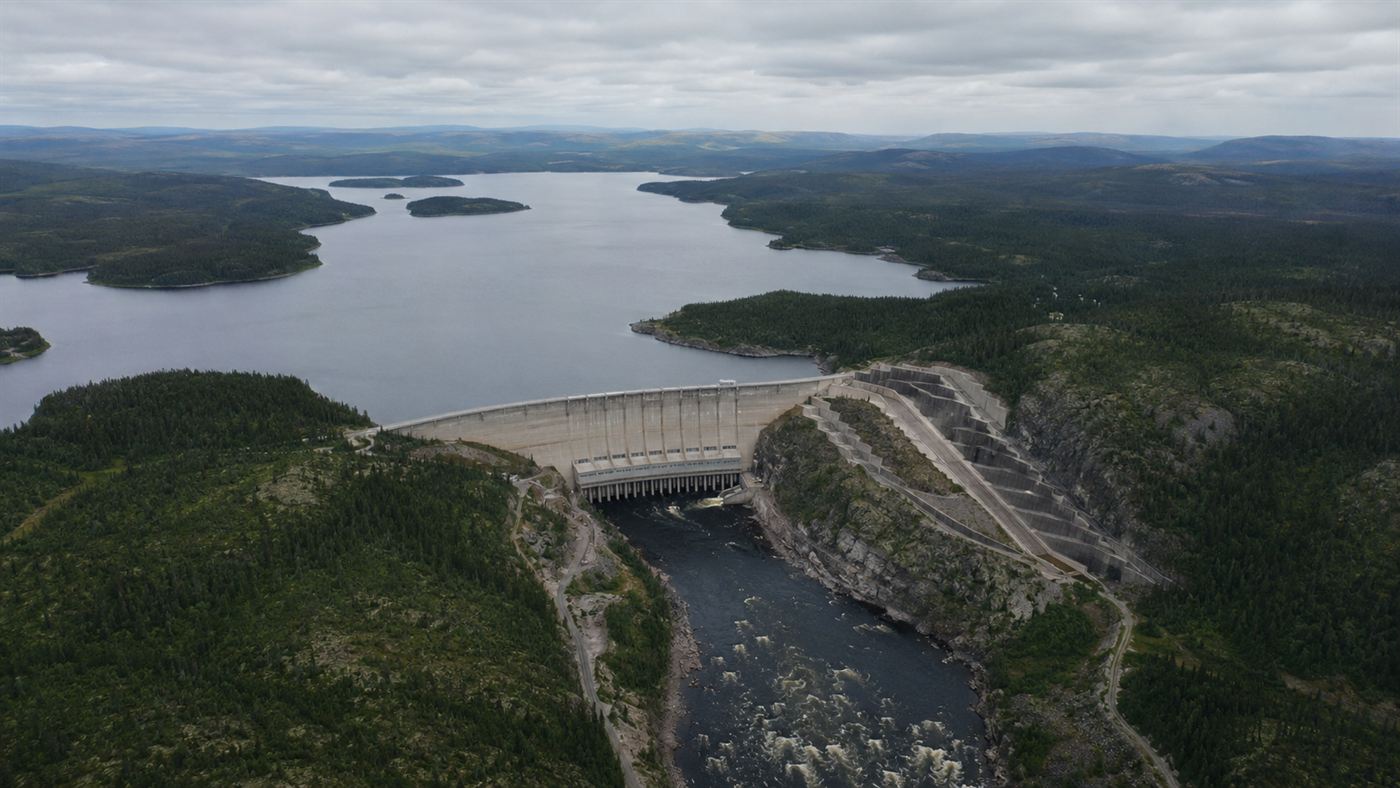 An aerial view of a huge hydroelectric dam and reservoir of the James Bay Project in the boreal forest of northern Quebec