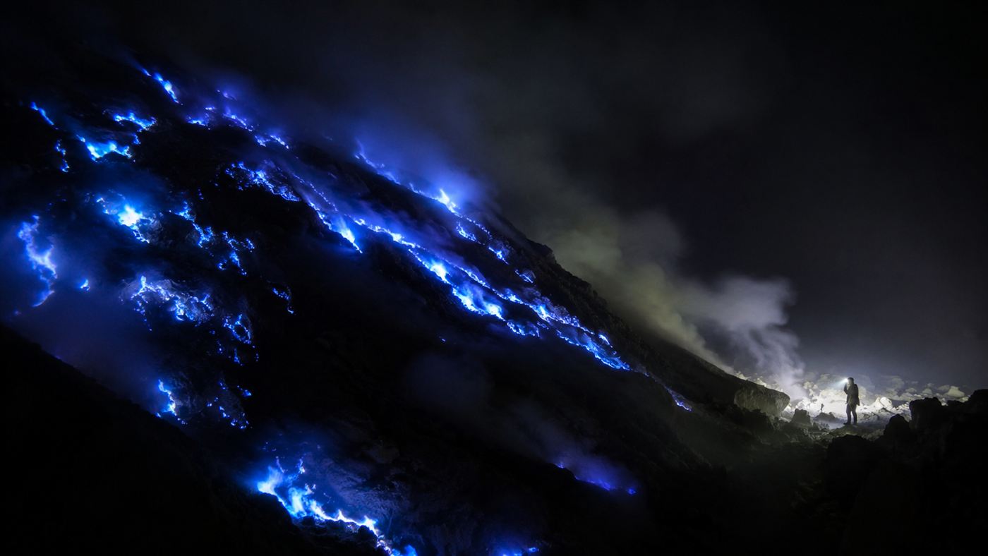 The blue fire glowing at night in the crater of Kawah Ijen volcano in Java
