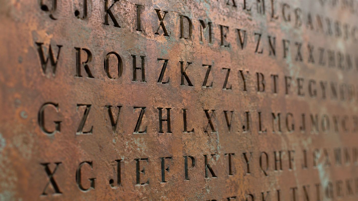 Close-up of the cut-out stencil letters forming the encrypted Kryptos cipher