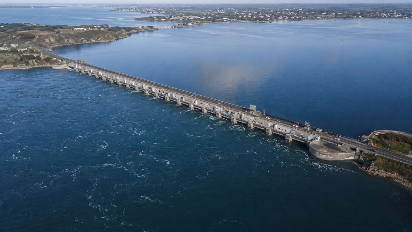 The long La Rance tidal barrage stretching across a wide estuary in Brittany with a road on top