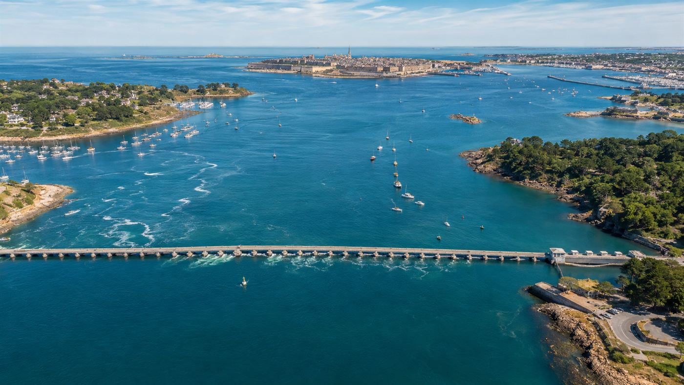 An aerial view of the Rance estuary in Brittany near Saint-Malo with the tidal barrage crossing the blue water