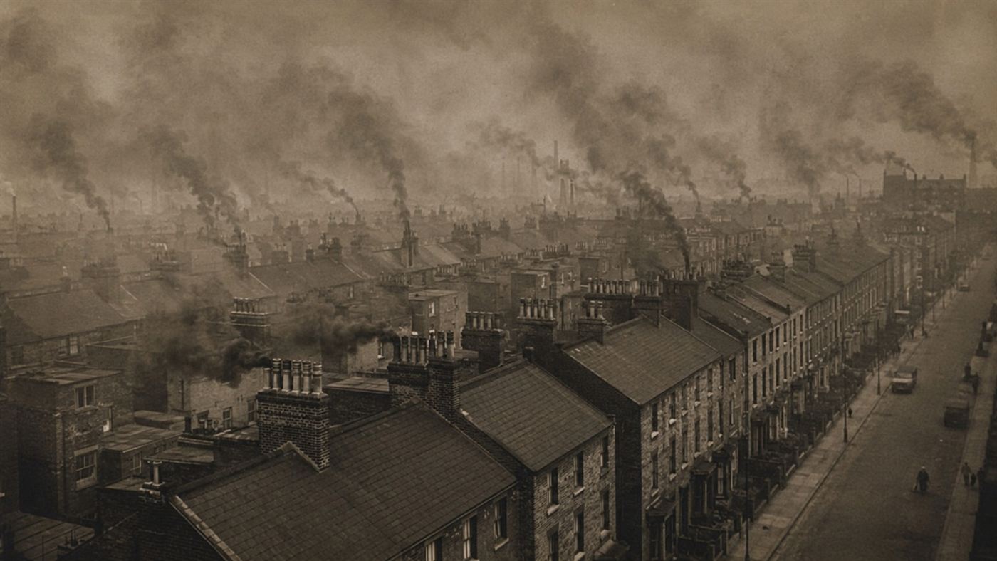 Hundreds of chimneys from rows of 1950s London terraced houses pouring thick coal smoke into a grey winter sky, aerial view of the city, industrial air pollution before the Clean Air Act
