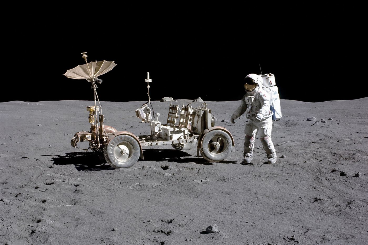 The Apollo Lunar Rover, an electric moon buggy with wire-mesh wheels, parked on the Moon
