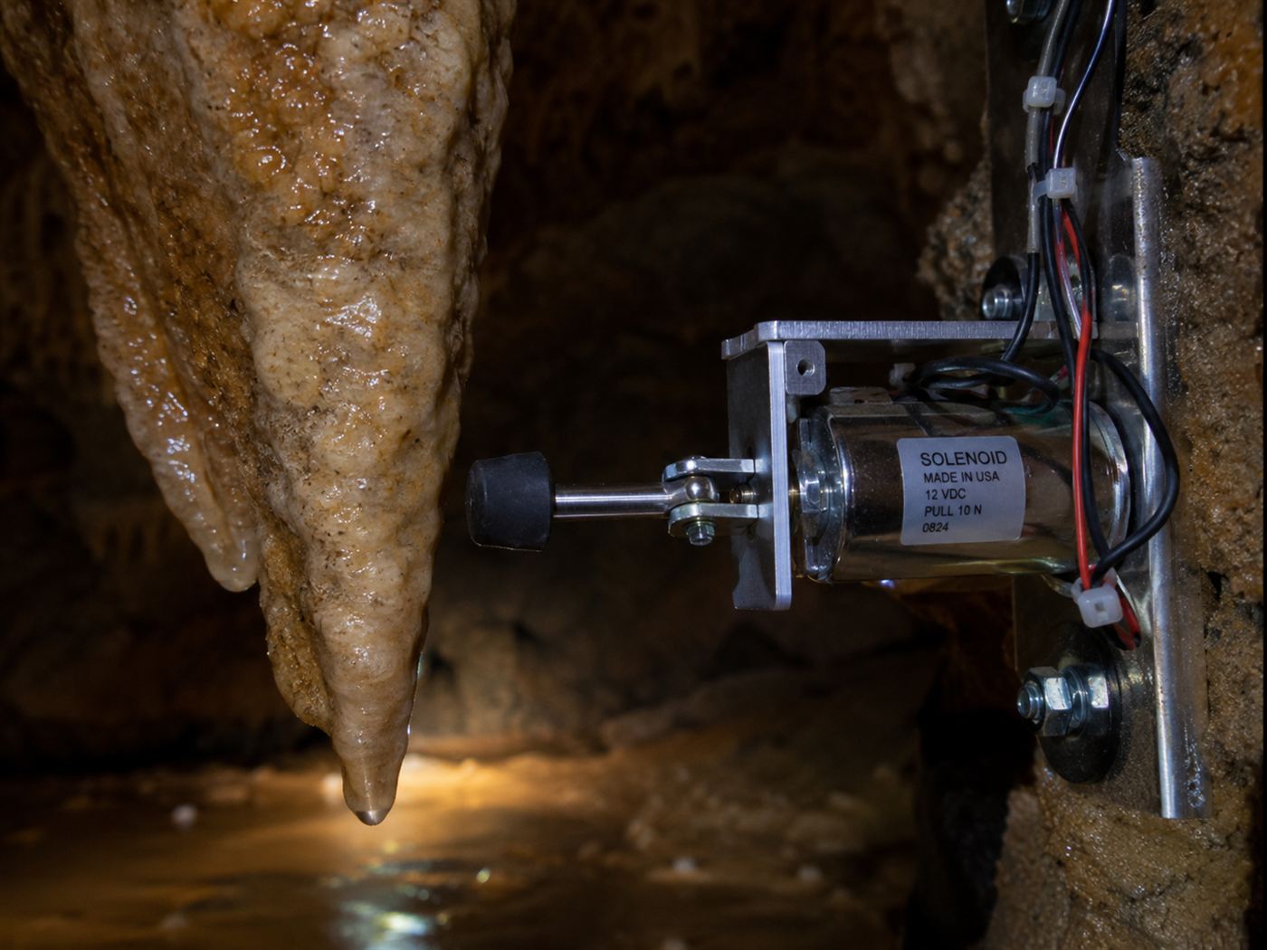 A rubber-tipped mallet on a solenoid mounted beside a stalactite, the mechanism of the Great Stalacpipe Organ