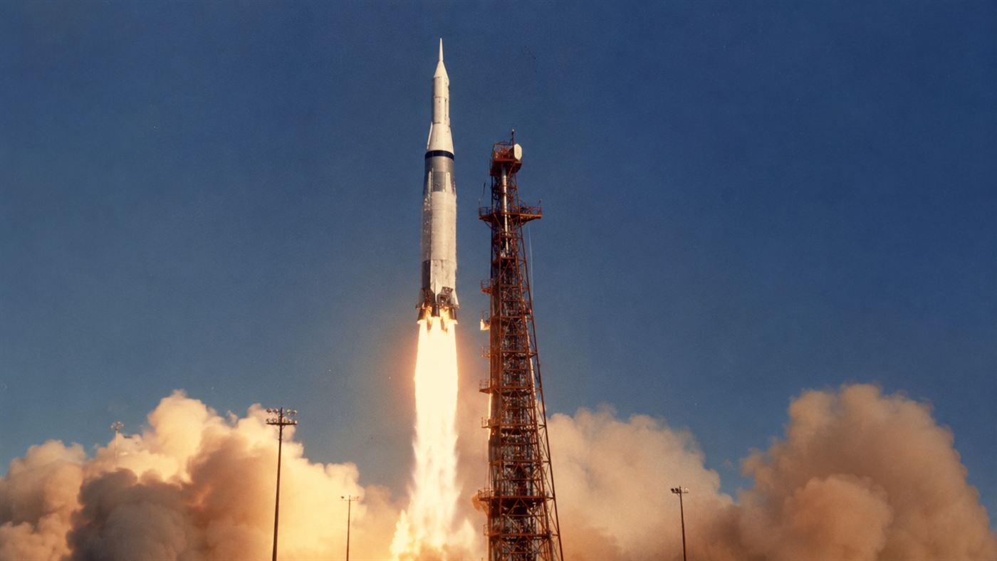 An Atlas-Agena rocket carrying Mariner 1 lifting off from Cape Canaveral in 1962 on a pillar of flame against a clear sky
