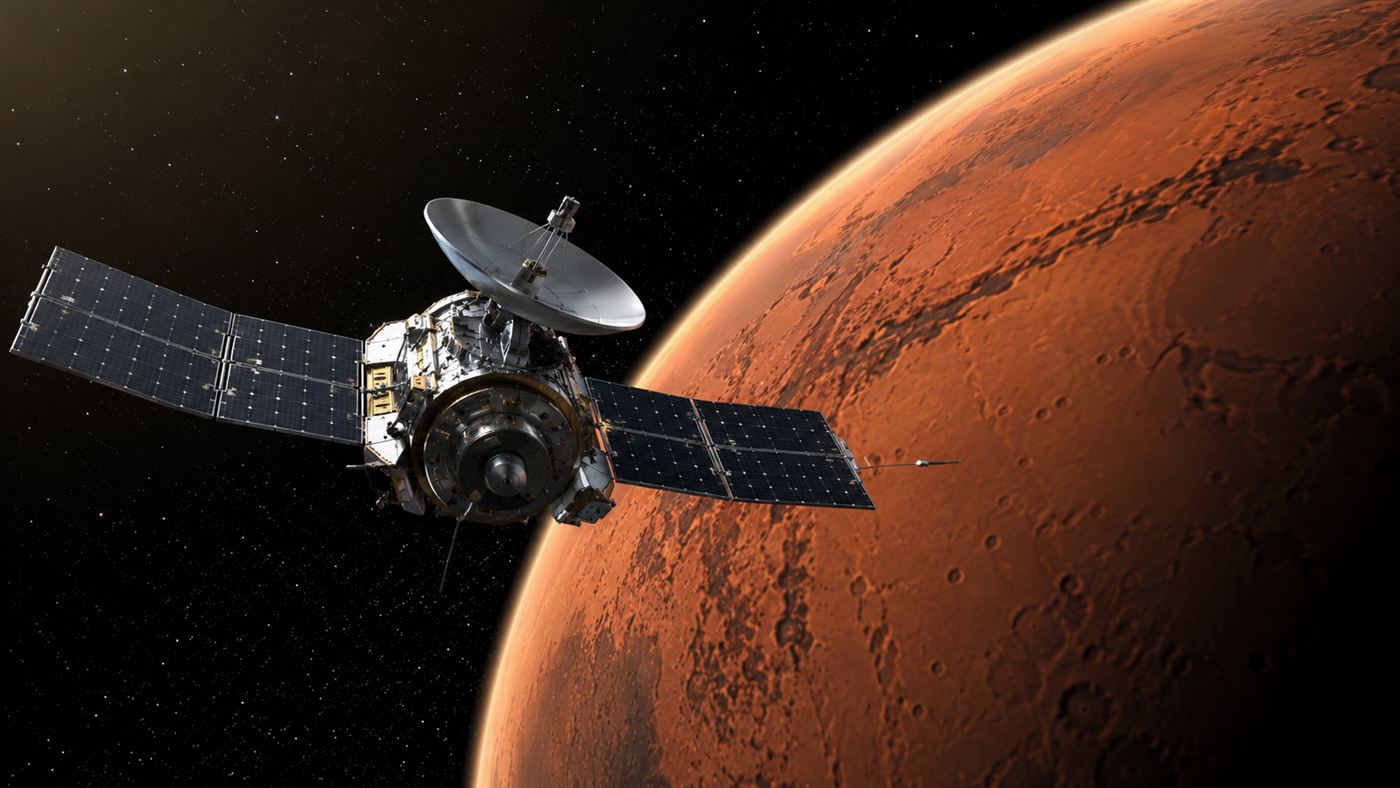 The Mars Climate Orbiter spacecraft approaching the red planet against black space