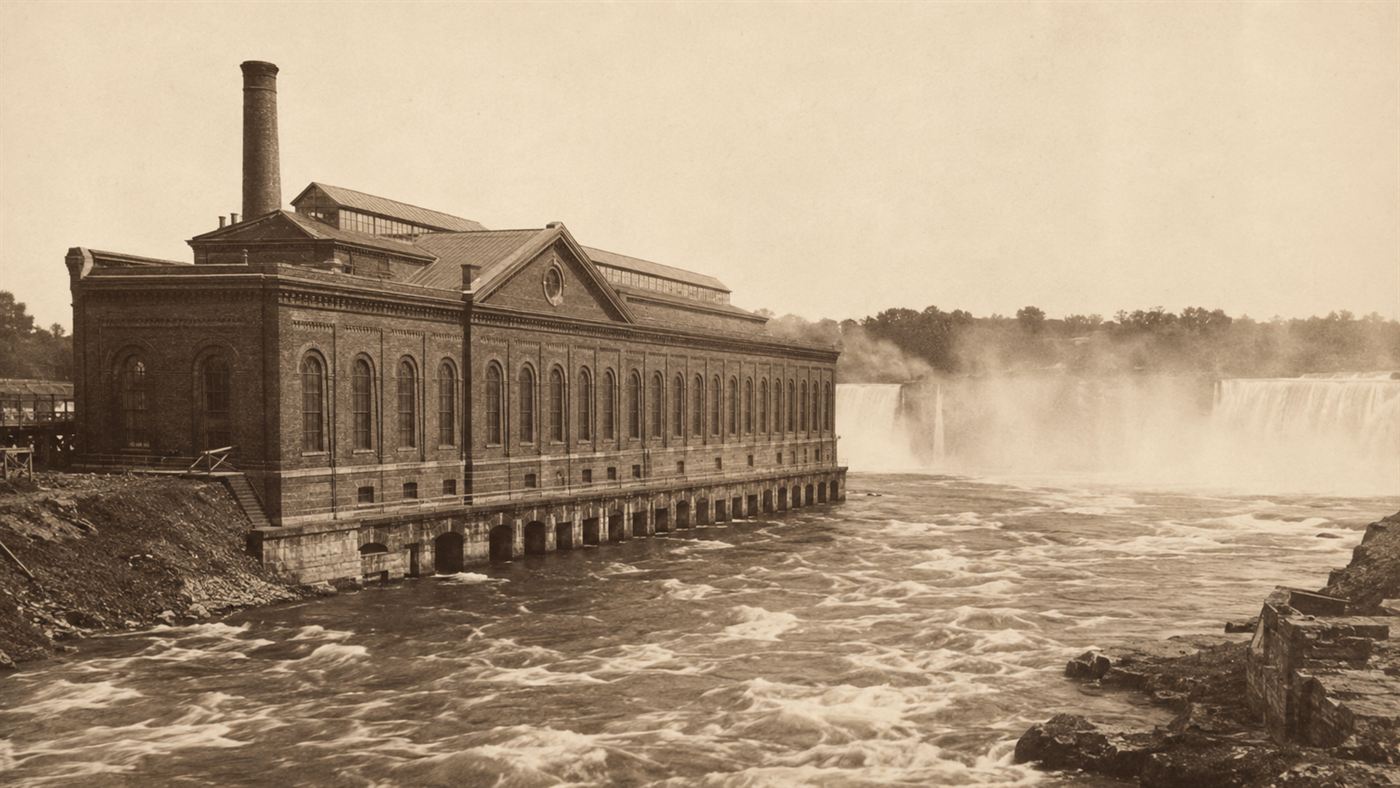 The Niagara Falls power plant of 1895 beside the thundering falls, an early hydroelectric station