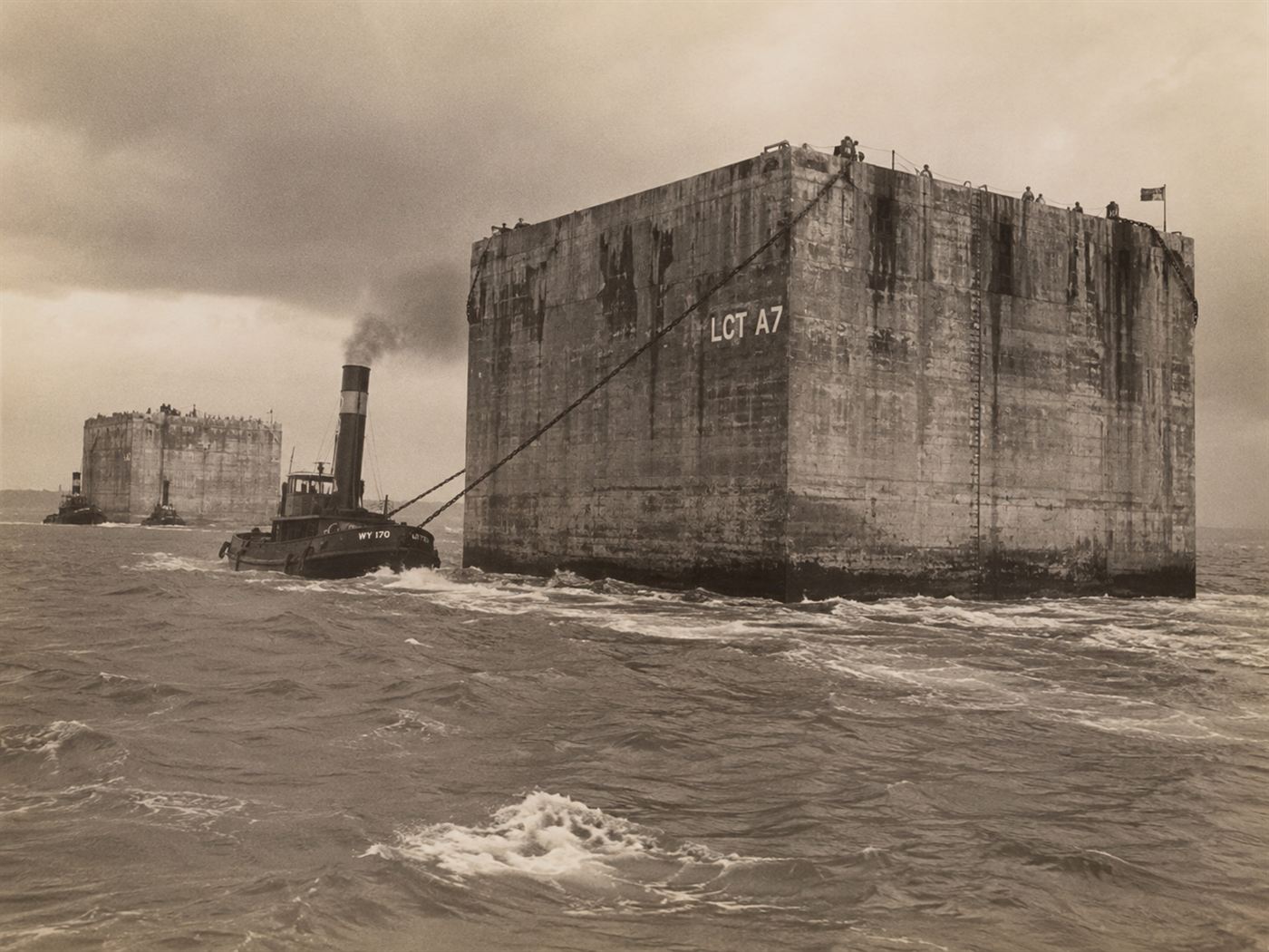 Enormous concrete Phoenix caissons being towed across the Channel by tugs, part of the Mulberry harbours