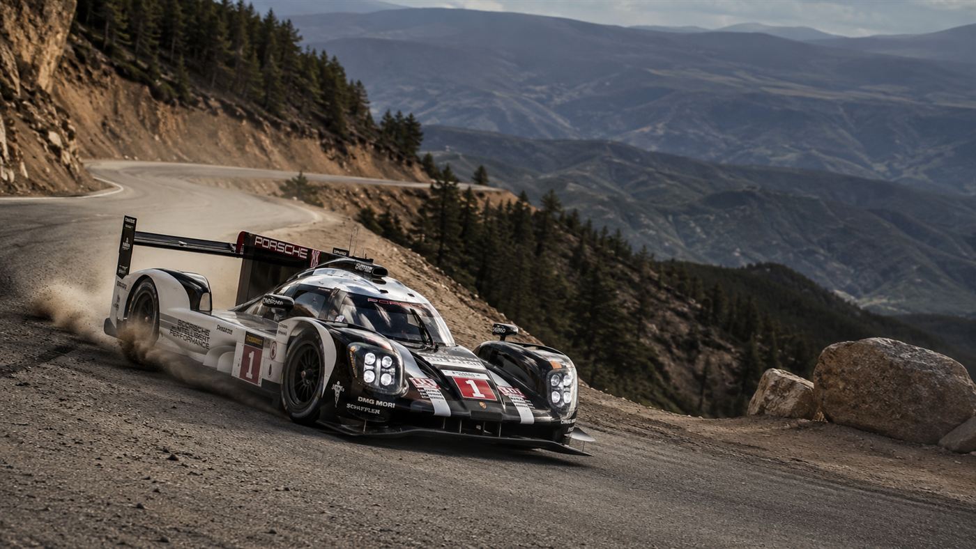 The electric Volkswagen ID.R race car cornering hard on a tight bend of the Pikes Peak mountain road