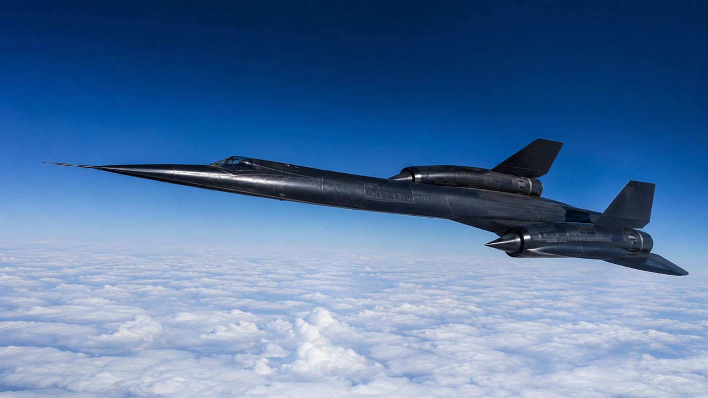 A sleek black SR-71 Blackbird reconnaissance jet flying high above the clouds