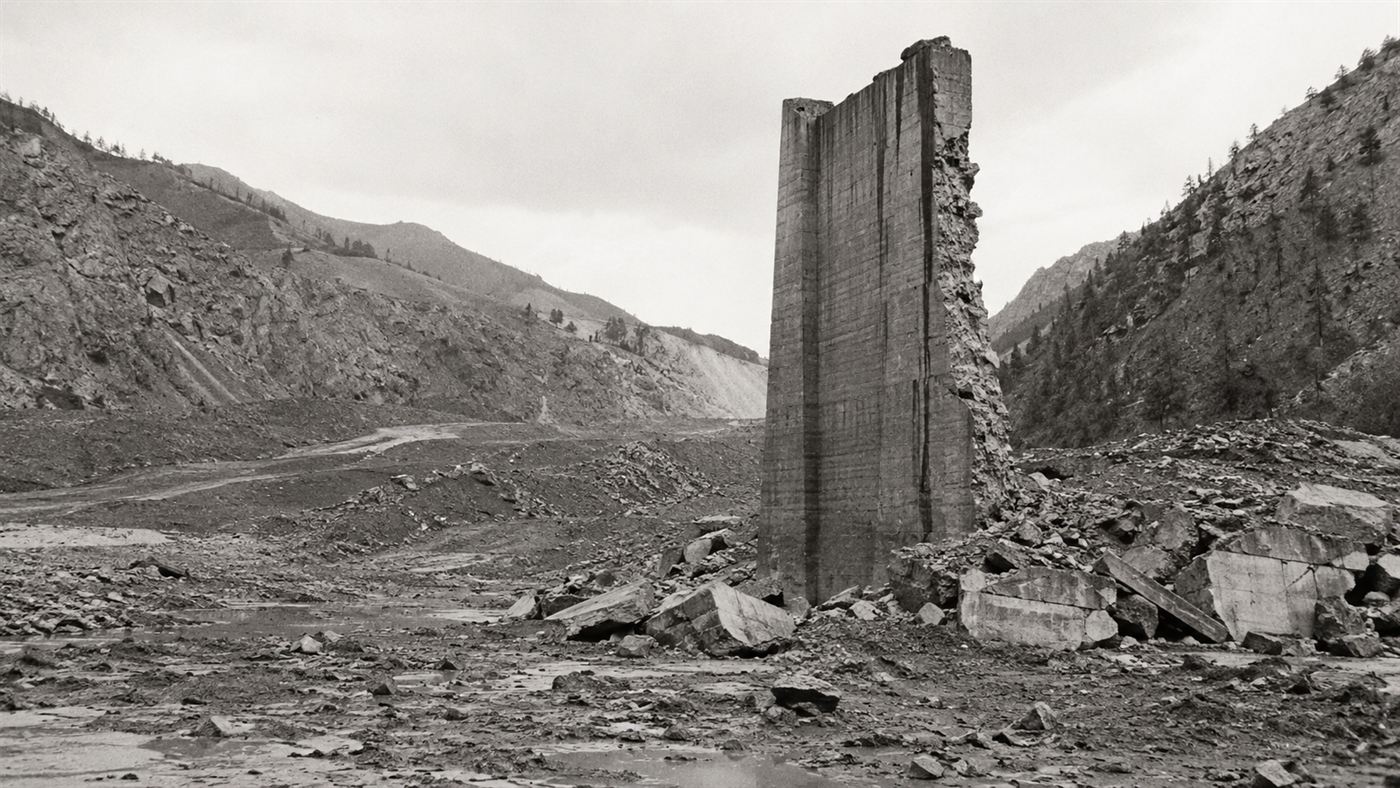The lone surviving concrete monolith of the St. Francis Dam in a wrecked canyon after the 1928 collapse