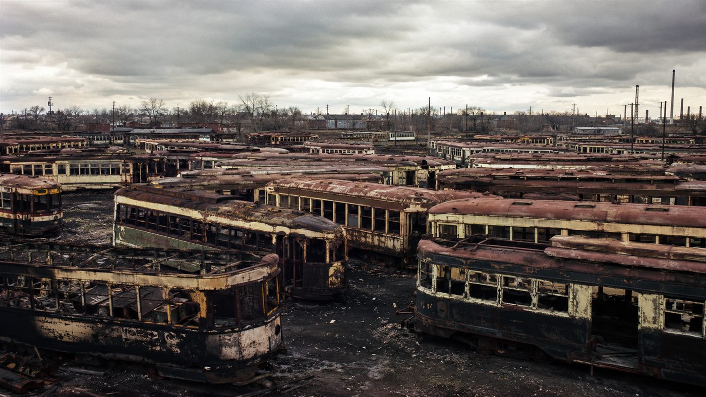 Scrapped streetcars piled in a junkyard at the heart of the streetcar conspiracy