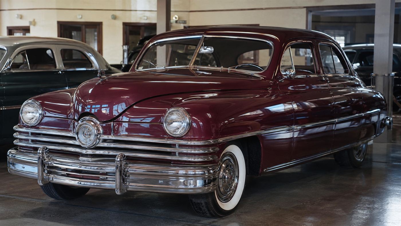 A 1948 Tucker 48 sedan with its distinctive central third headlight in a showroom