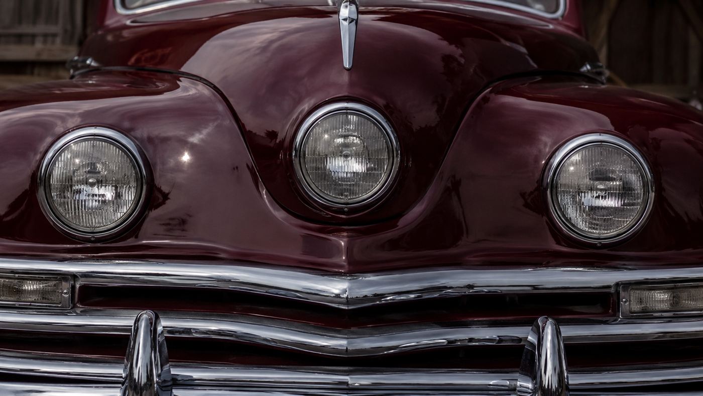 The central third Cyclops headlight between two outer headlights on the front of a 1948 streamlined car