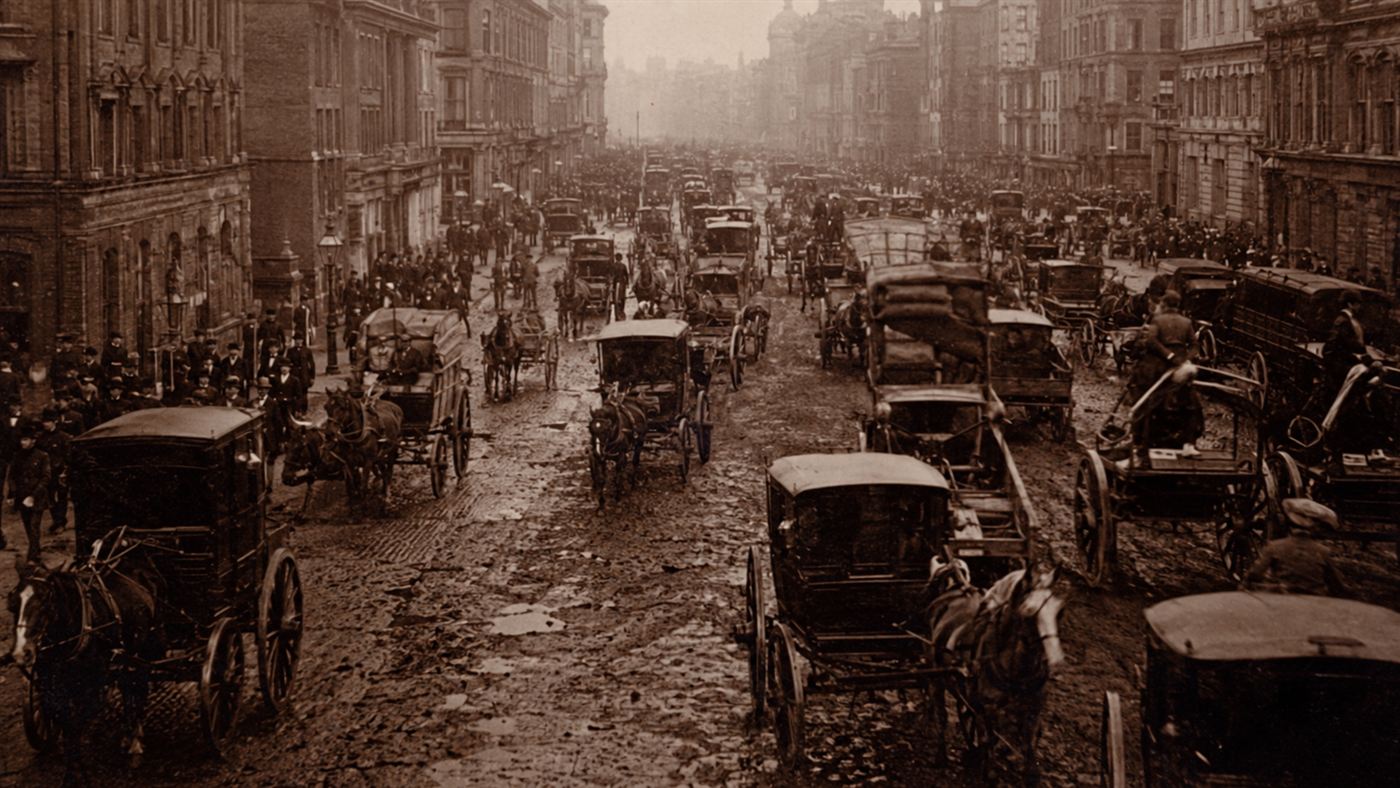 A crowded Victorian city street packed with horse-drawn carriages and carts during the horse manure crisis