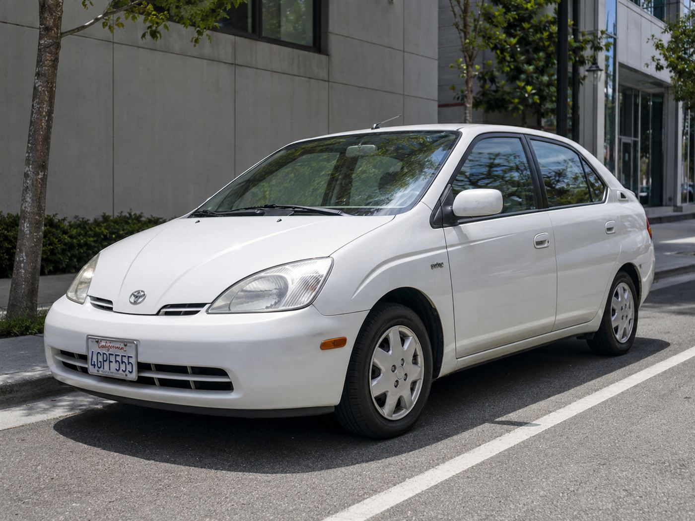A white late-1990s hybrid sedan, the kind of car that vindicated Victor Wouk decades after his prototype