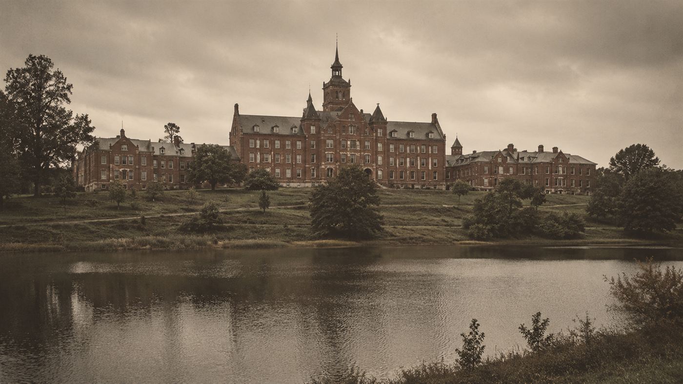 The large Victorian brick buildings of Willard State Hospital standing above Seneca Lake in upstate New York