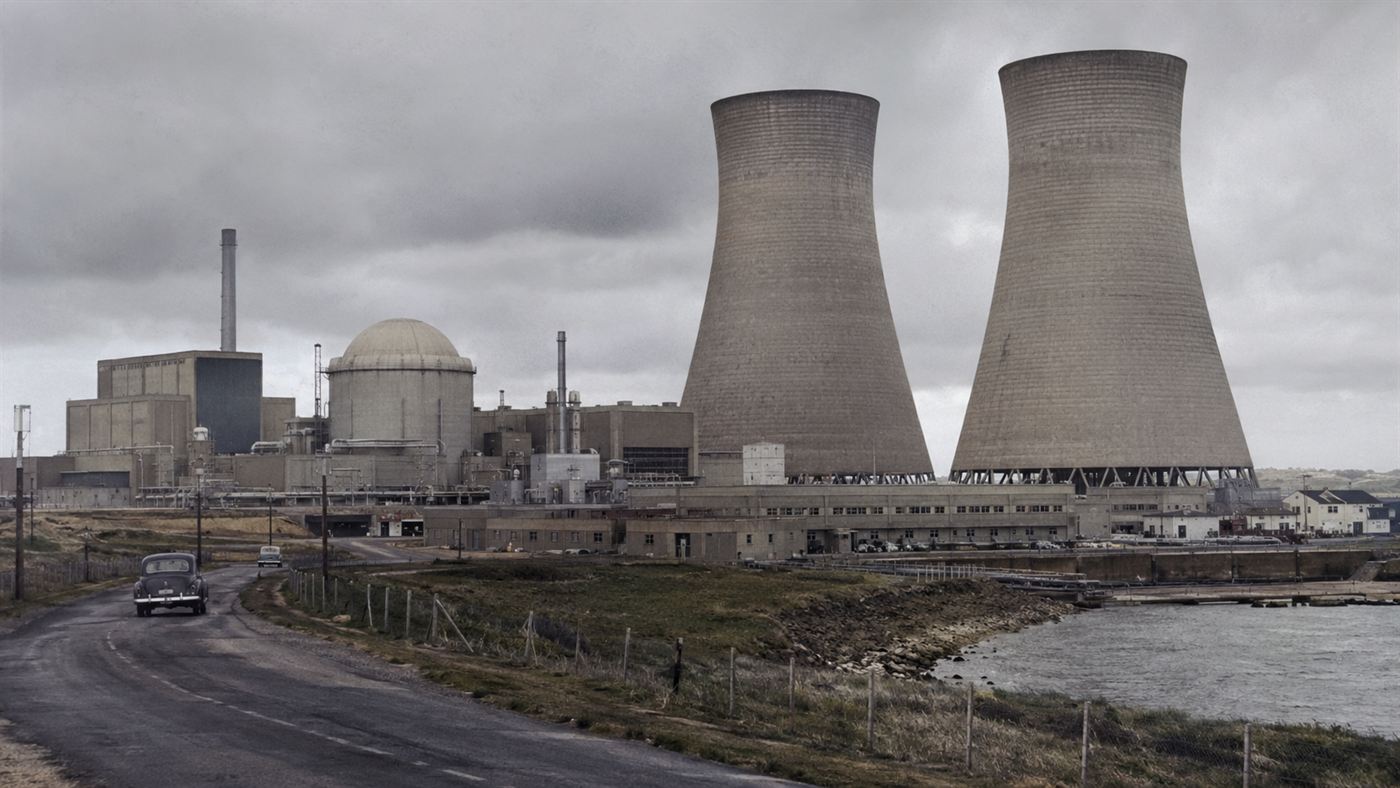 Windscale nuclear reactor complex with two large concrete cooling towers rising above the Cumberland coastal plain in northwest England, 1950s atomic age industrial facility before the 1957 fire