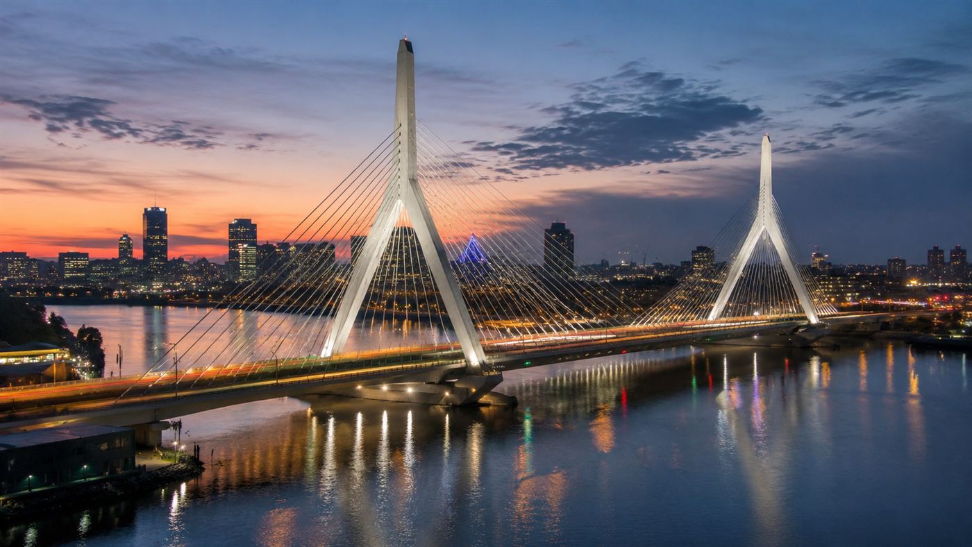 A white cable-stayed bridge with twin towers over a river beside a city skyline, like Boston's Zakim Bridge