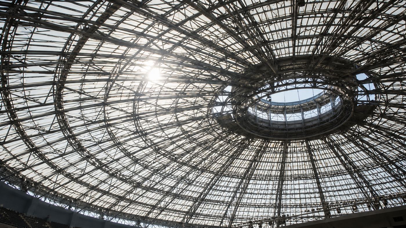 Looking up at the Astrodome's translucent paneled dome roof crisscrossed with a steel lattice, bright glare