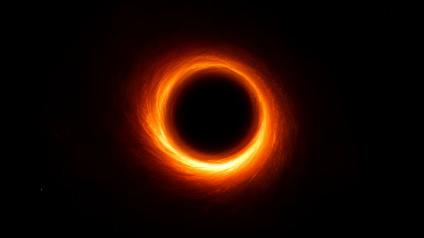 The first black hole image, a glowing fiery orange ring of light around a dark circular shadow at its center against the black of space