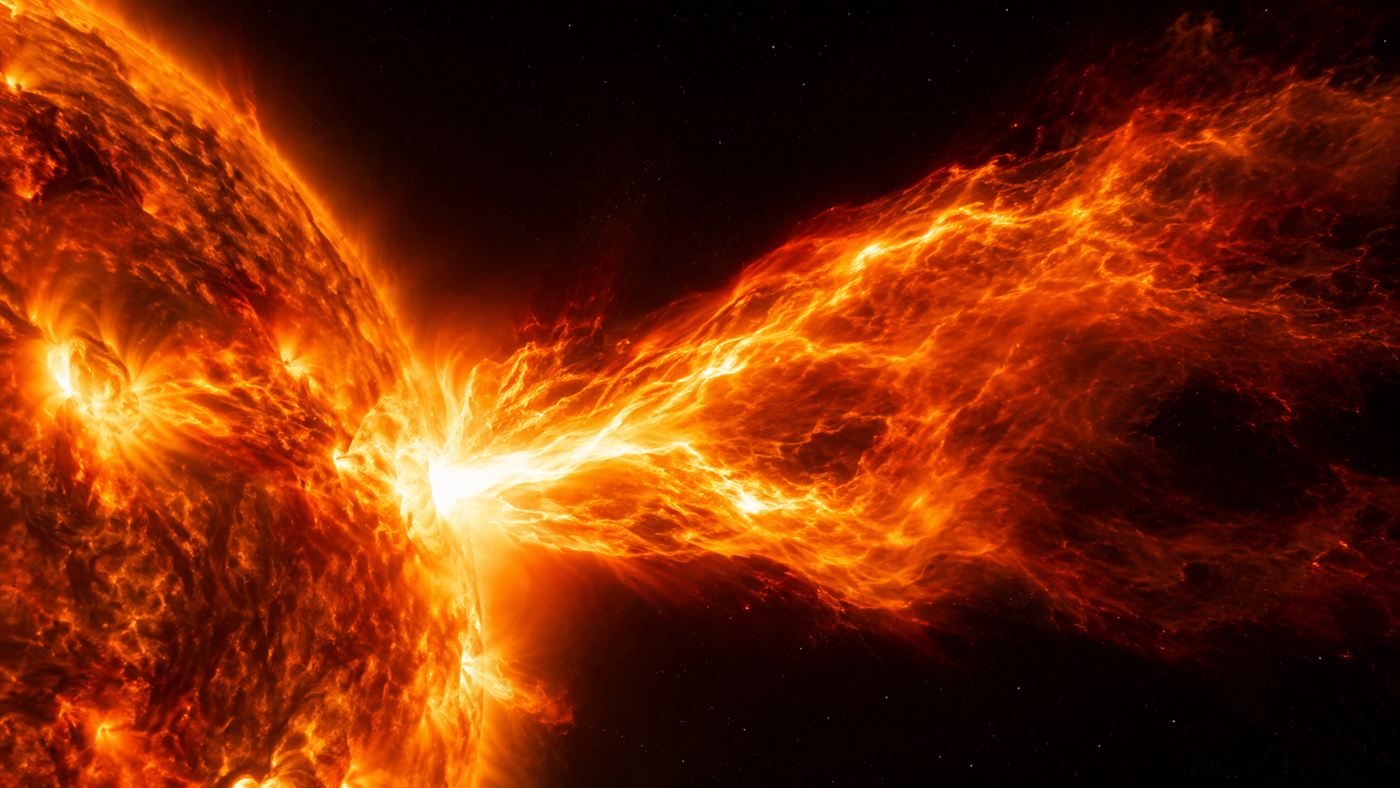The Sun erupting an enormous coronal mass ejection, a vast cloud of glowing plasma blasting out across space toward Earth