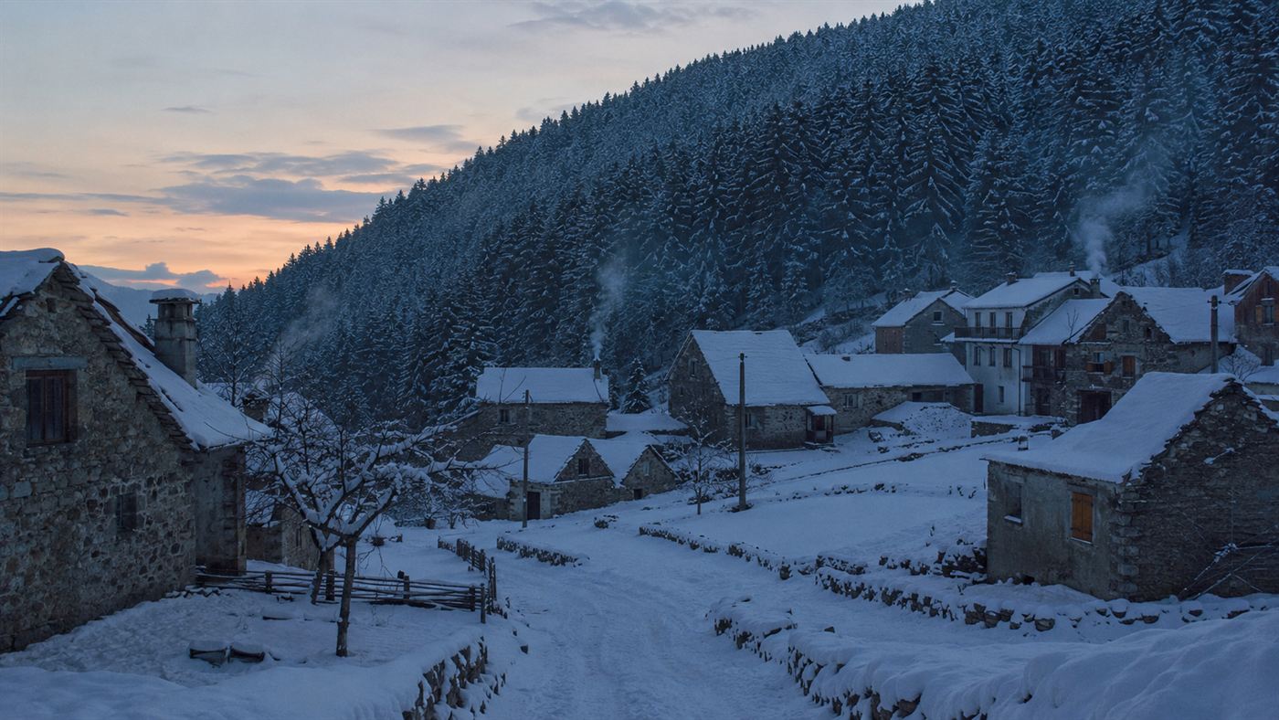 A snowbound Central European mountain village below dark pine forest in winter, near where the wreckage of Vesna Vulovic's flight came down
