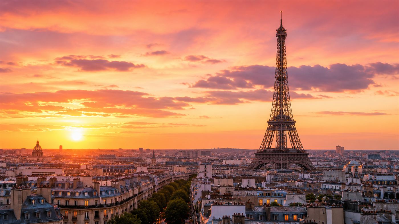 The wrought-iron Eiffel Tower rising over Paris at golden hour, its lattice silhouette against a warm sky