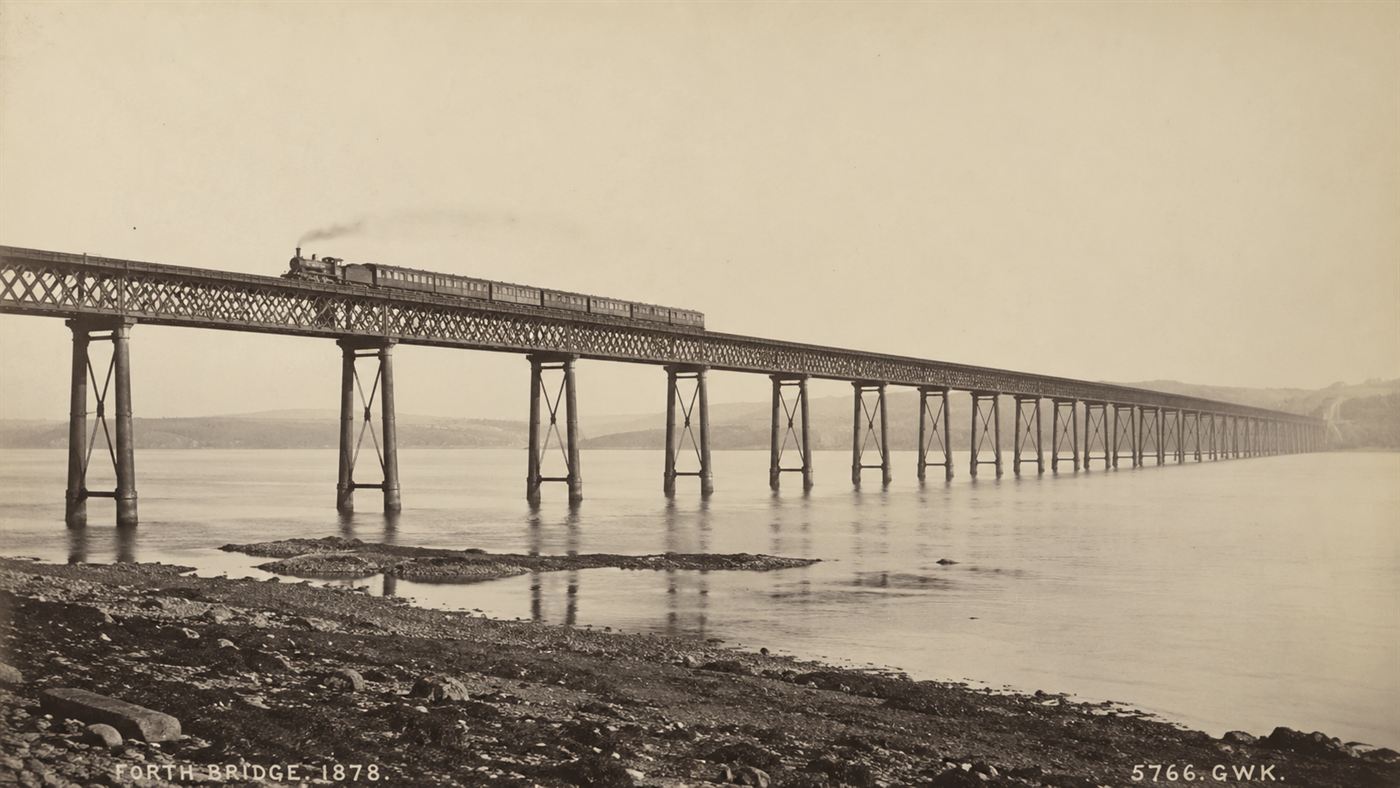The original long Victorian iron lattice railway bridge spanning the wide Firth of Tay, intact before the disaster