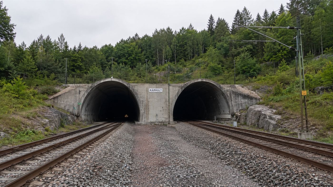 The twin-bore Hallandsås Tunnel portal cut into a green forested ridge in southern Sweden