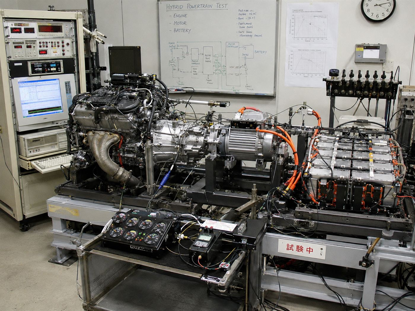 A 1990s hybrid car powertrain on a test bench with engine, motor and battery, like the troubled Toyota Prius development