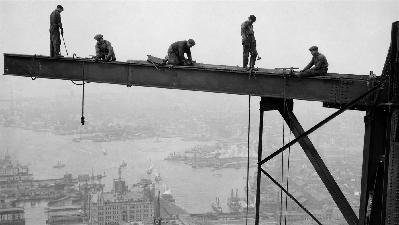 Mohawk ironworkers from Kahnawake balancing on high steel girders during bridge construction in the early 1900s