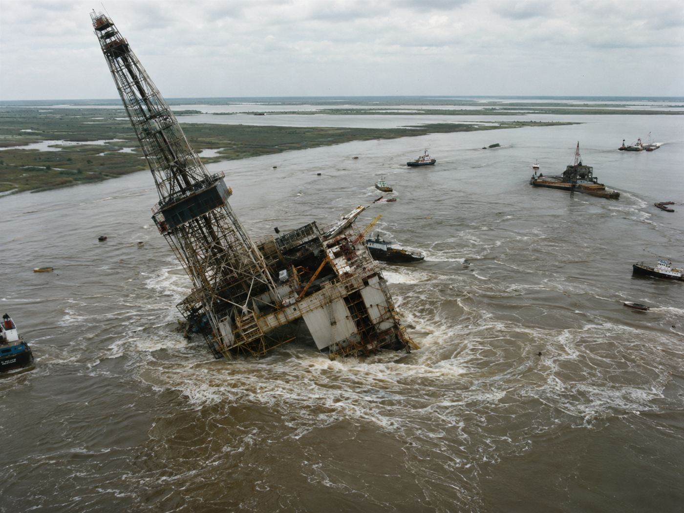 Texaco oil drilling platform tilting into the Lake Peigneur whirlpool as the salt mine below collapses