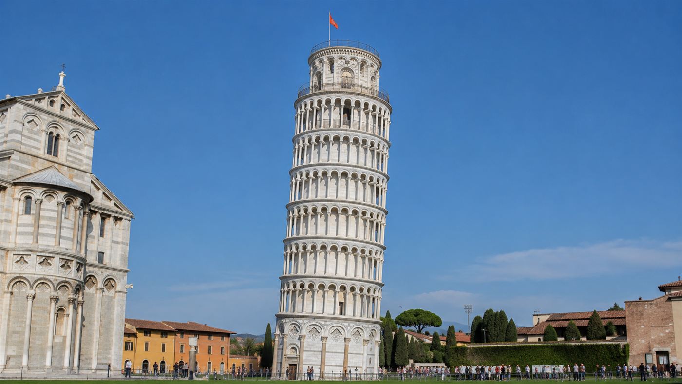 The white marble Leaning Tower of Pisa tilting against a clear blue sky