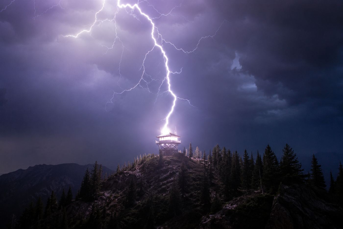 Lightning striking a wooden fire lookout tower, like the one where Roy Sullivan was first struck in 1942